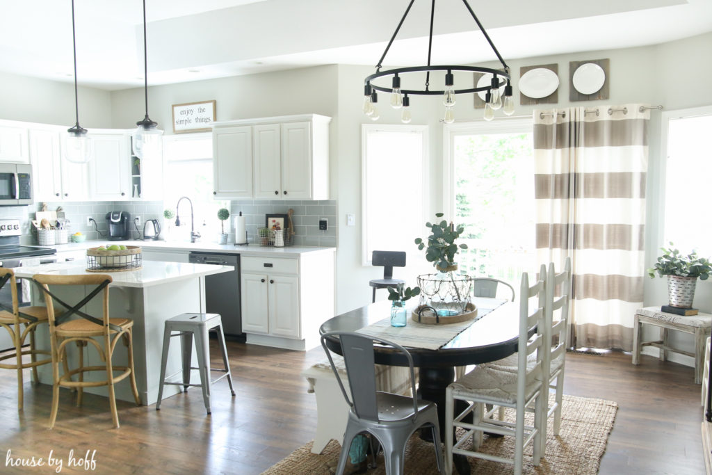 The kitchen and dining room before with striped curtains.