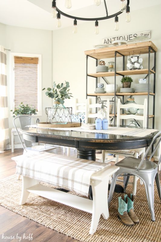 The dining room table with cowboy boots by the table.