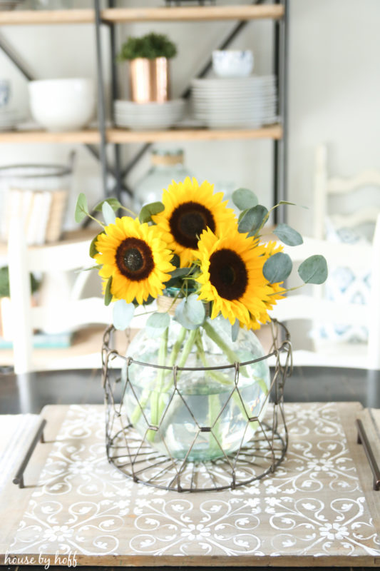 Sunflowers in a clear glass vase on the DIY serving tray.