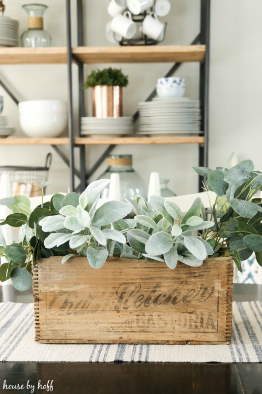 Putting the greenery into the wooden box.