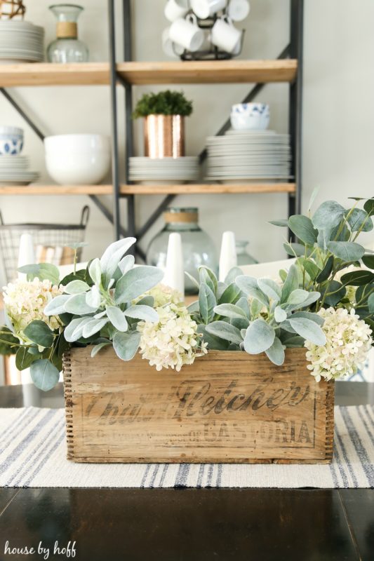 Adding the white hydrangeas to the the wooden crate.