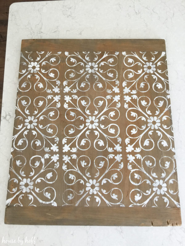 The floral stencil in white on the tray.