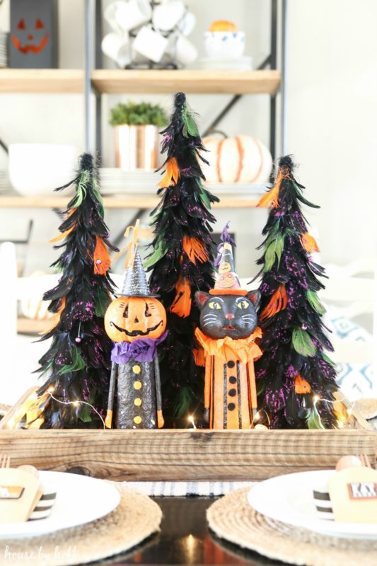 Cute Cat and Pumpkins figurines on the table as centerpieces.