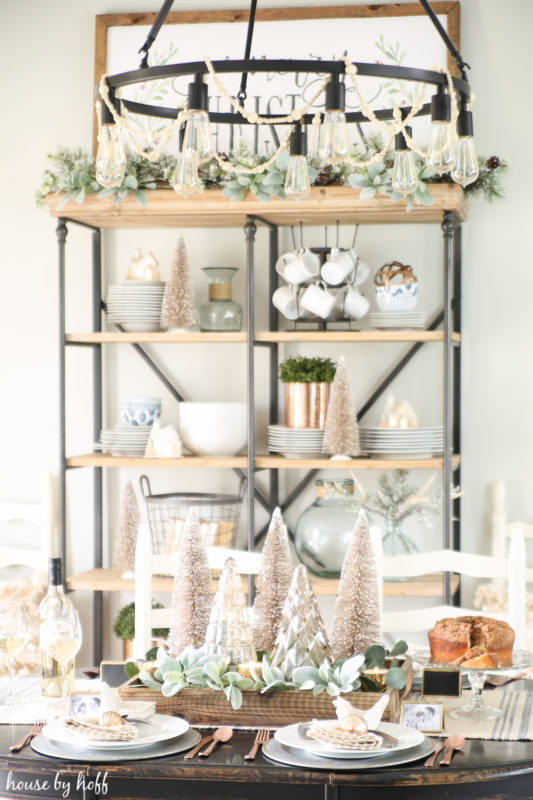 Open shelving with Christmas decor on it, plus tea cups.