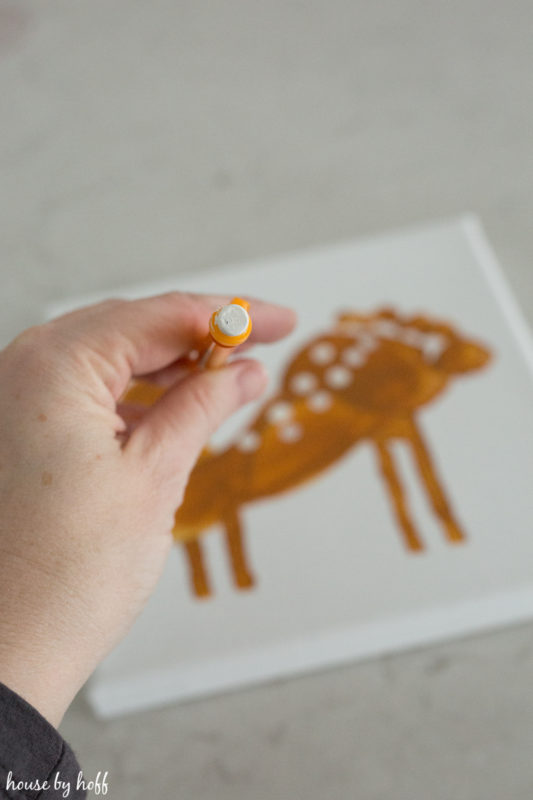 Stamping white spots on the deer.