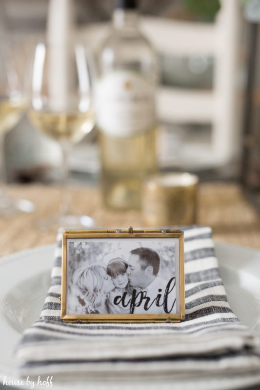 A picture of a family in a little gold frame on the table.