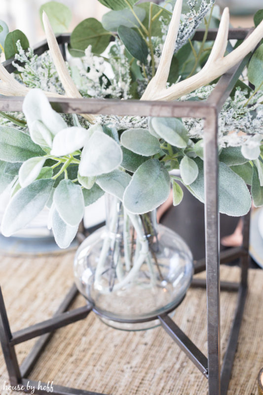 Winter greenery, and an antler as the the centerpiece.