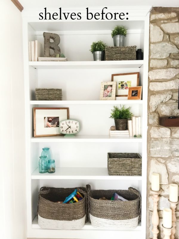 Wooden baskets, a clock and plants on open shelves.