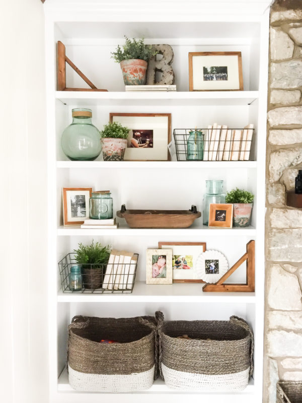 Large baskets on bottom shelf and wire baskets, and plants.