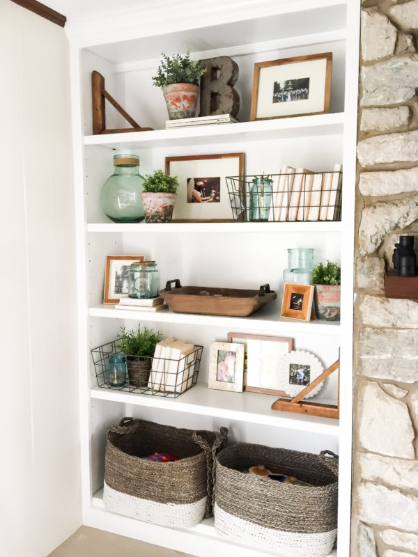 White open shelving with vases and plants on it.