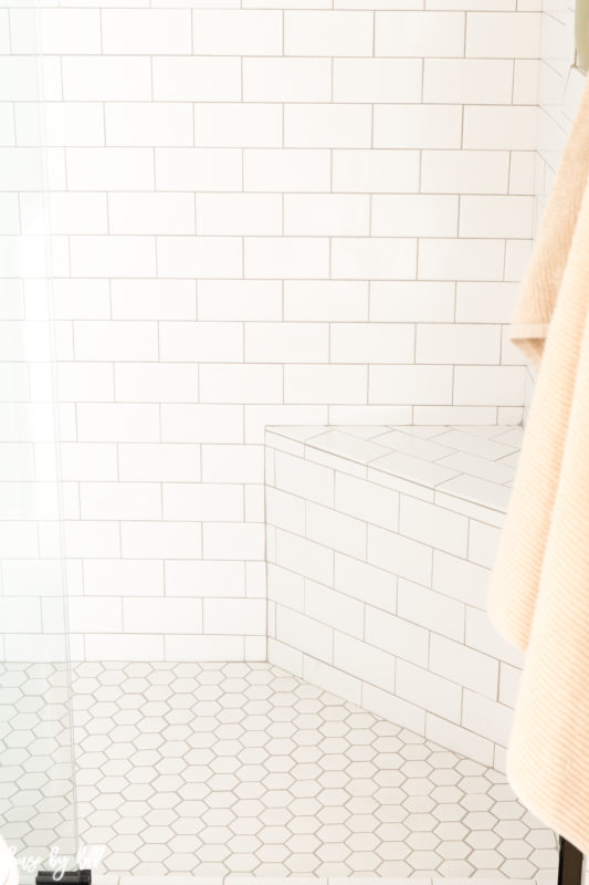 Hexagon tiles on the bottom of the shower in bathroom.