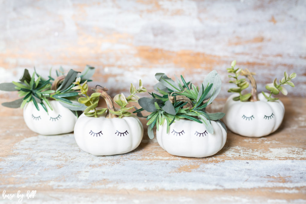 Leaves coming out of the little white pumpkins with eyelashes on them.