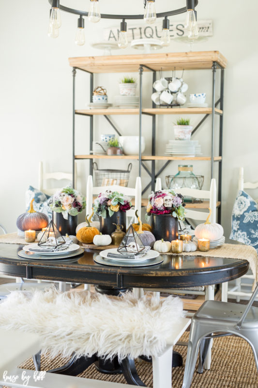 Dining table with shelf unit behind it.