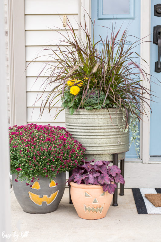 Three planters with flowers the front porch.