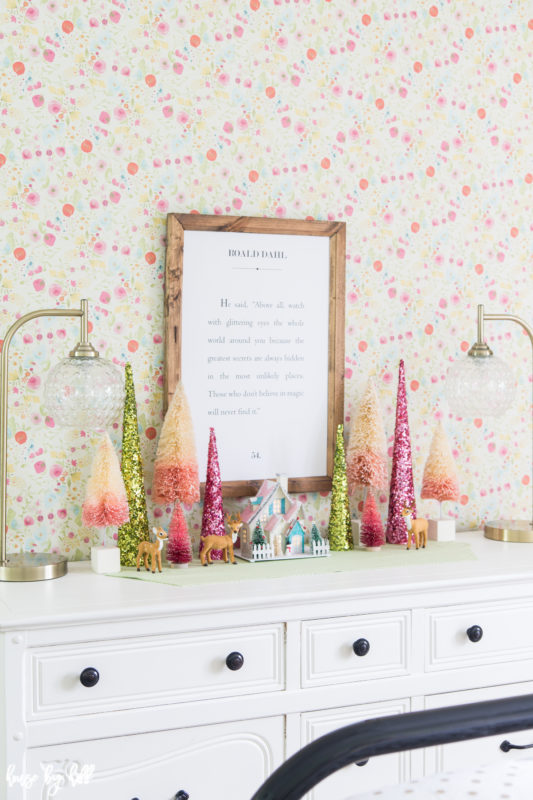 Colorful pink and green Holiday Decorations on White Dresser. 