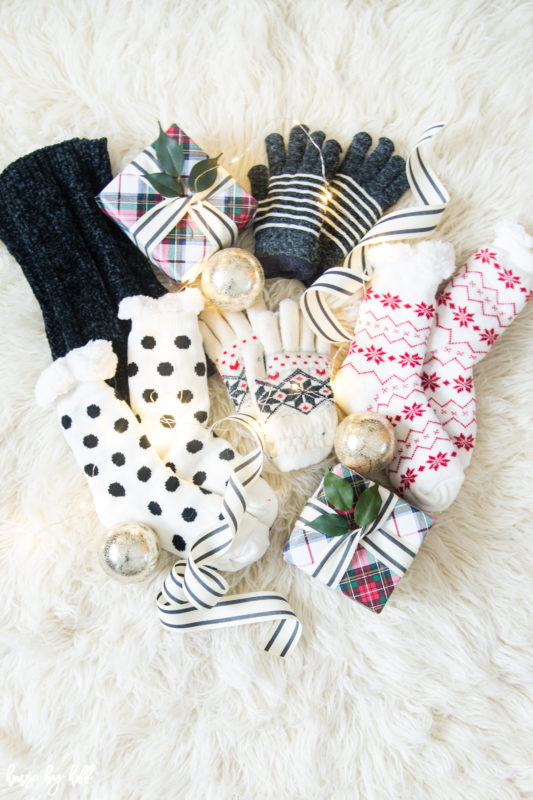 Wrapped presents, reading socks, mittens on white faux fur.