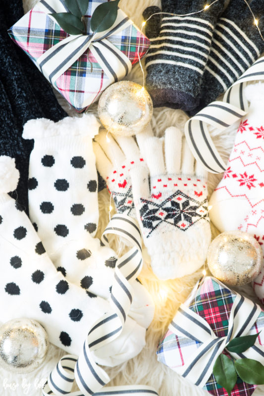 Black and white polka dot reading socks, black and white striped mittens on faux fur.