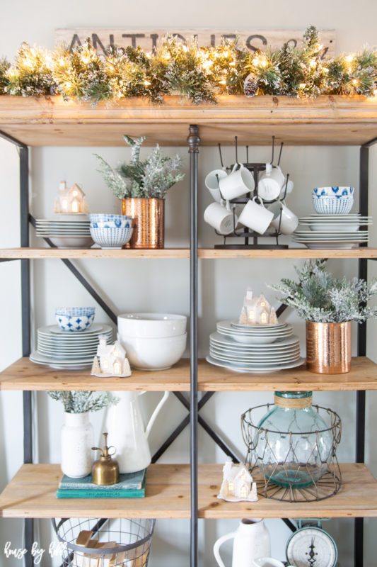 Very top of shelving unit with holiday garland lit up.