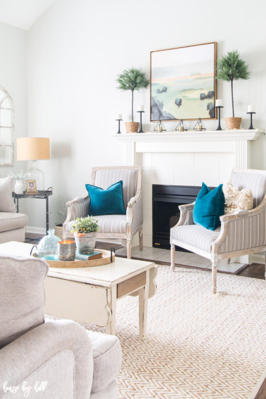 Bright and Simple Winter Living Room with two white armchairs flanking a fireplace.