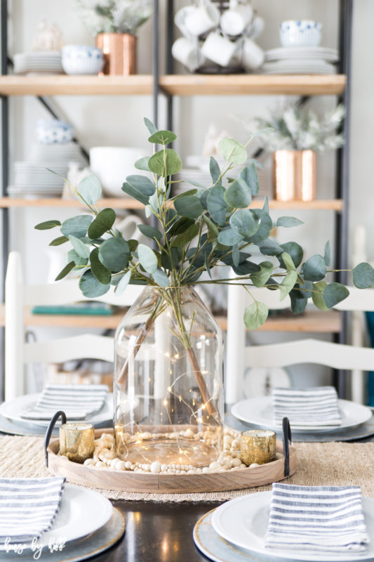 Eucalyptus branches in a clear vase on the table.