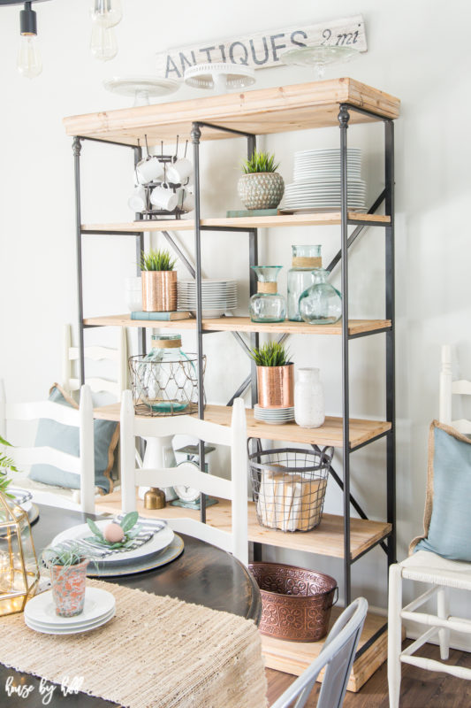 The open shelving with plates, wire baskets and copper vases.