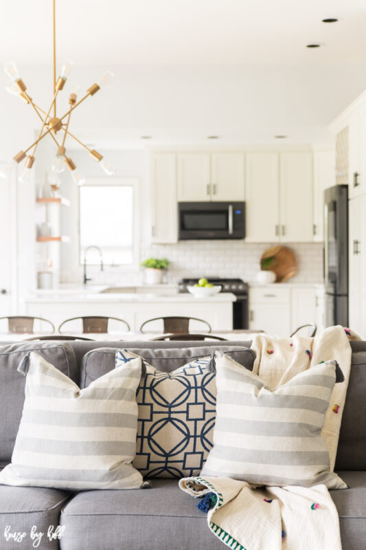 Renovated Open Concept Home with White Kitchen and Modern Chandelier.