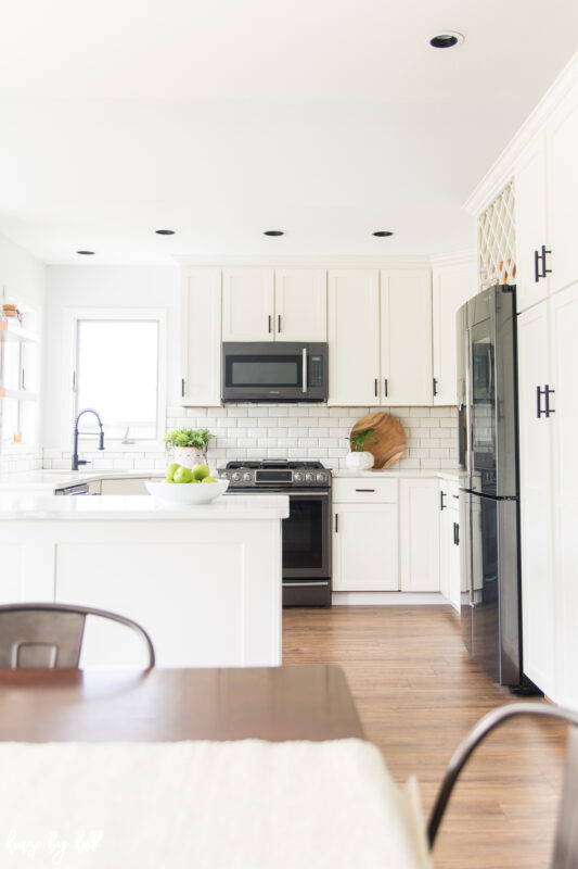 White kitchen cabinets and a wood floor.