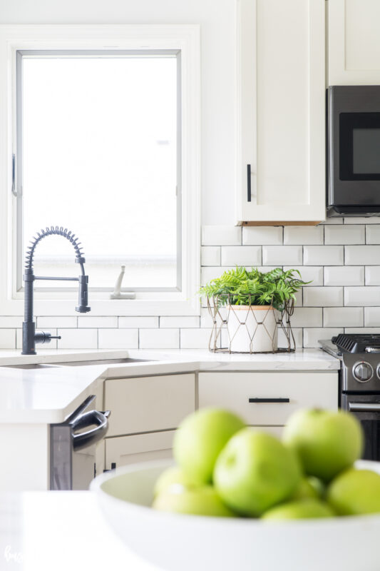 White subway tile and dark grout in the kitchen.