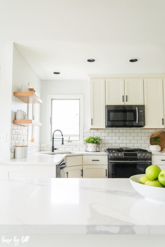 Black handles are on the cabinets in the kitchen.