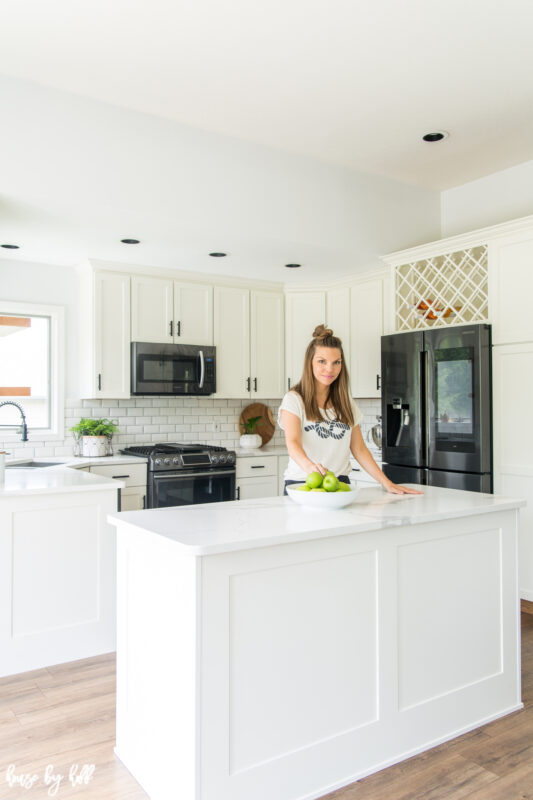 April's neighbor is in her new kitchen.