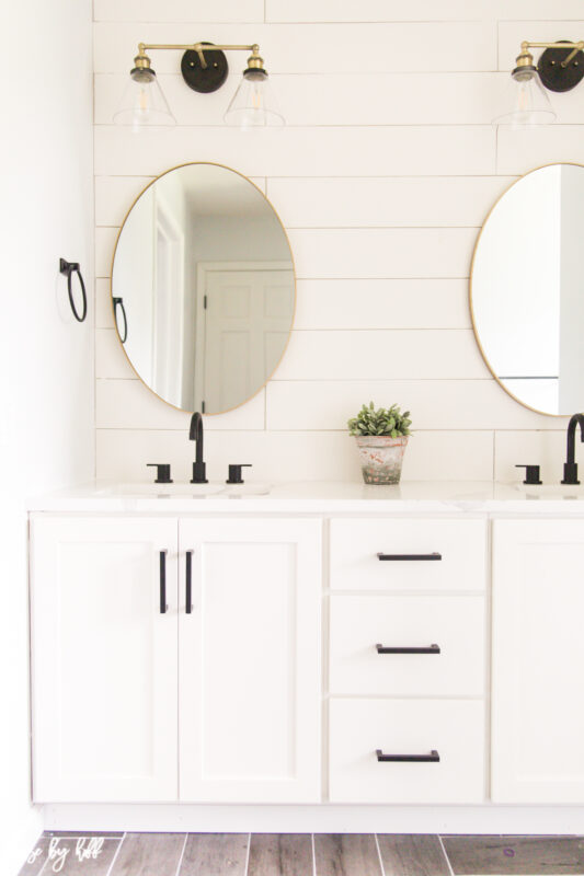 Renovated Guest Bathroom with Shiplap and Brass Light Fixtures.