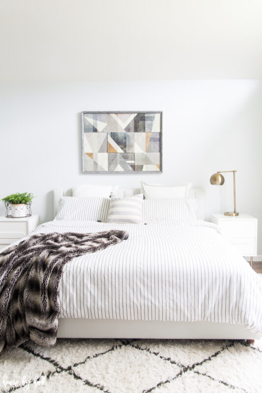 Bright and Simply Decorated Master Bedroom with a white and black rug.