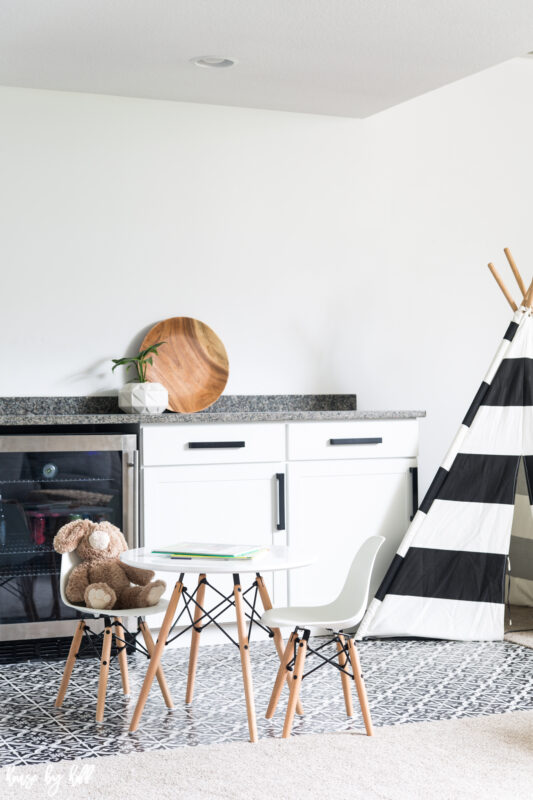 Modern Black and White Basement Kitchenette with a small table and a child's teepee set up.