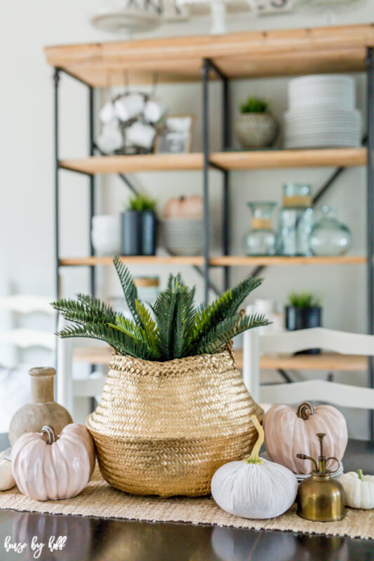 Pinky blush velvet pumpkins are on the table beside the seagrass basket.