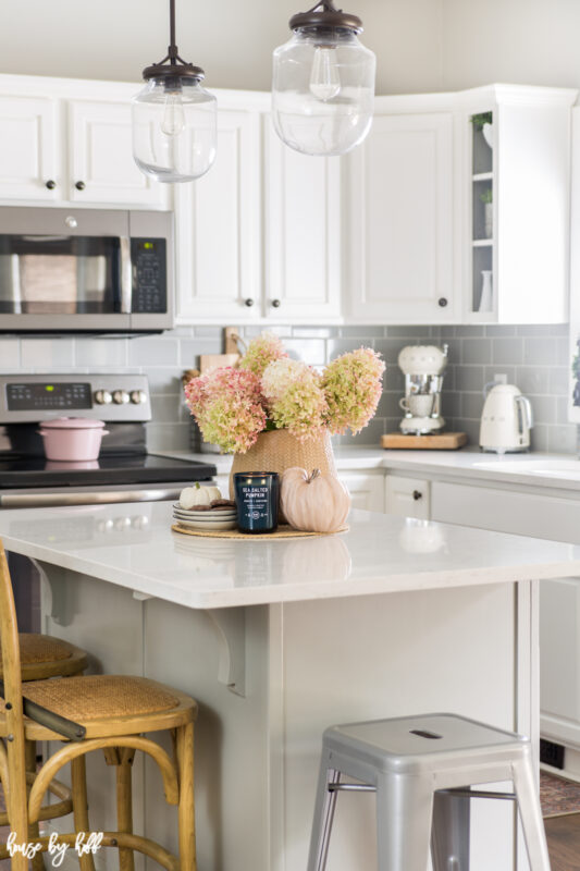 White Kitchen Decorated with Hydrangeas and a white kitchen island.