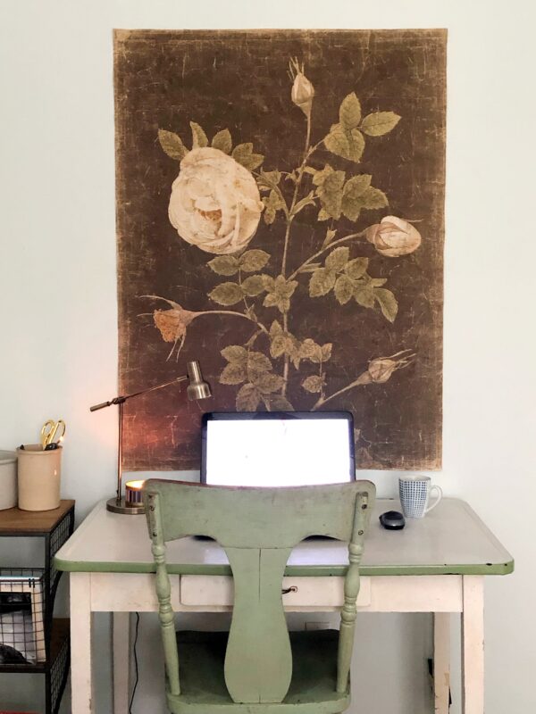 A small antique desk with a laptop on it.