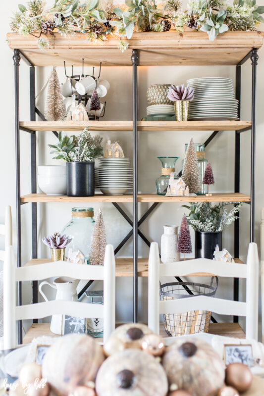 Open Shelving Decorated with Bottle Brush Trees and hints of pink.