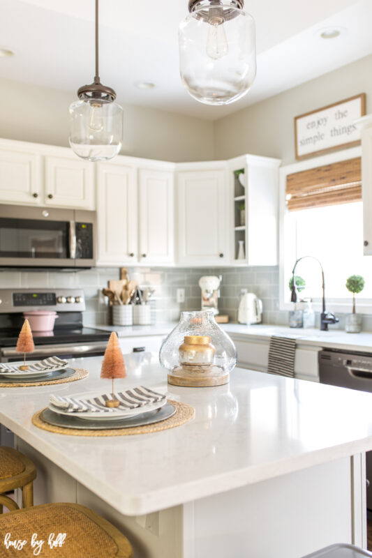 The kitchen island with a table setting on it.