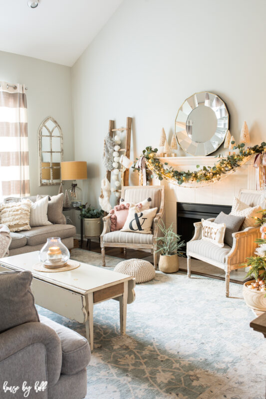 Holiday living room decorated with pink and cream holiday decor.