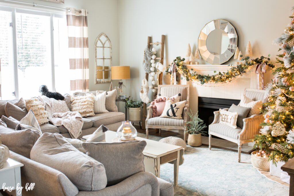 Living Room with Rose Gold and Pink Holiday Decorations and a Christmas tree in the corner of the room.