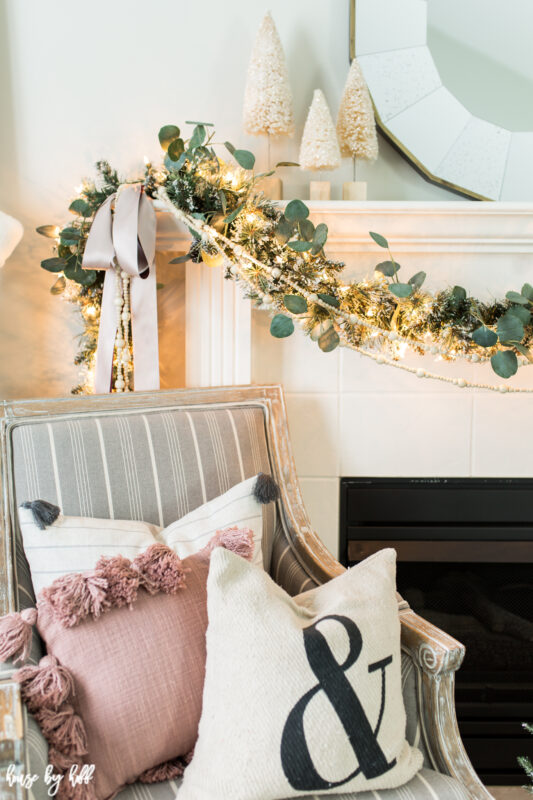 Up close picture of the garland with eucalyptus and a bow on the fireplace mantel.