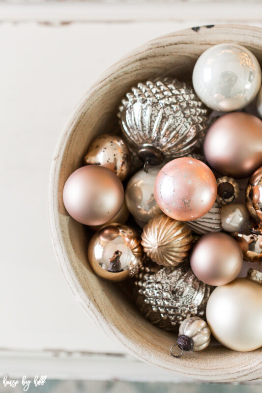 Big Wooden Bowl on Coffee Table with Vintage Rose Gold and Cream Ornaments