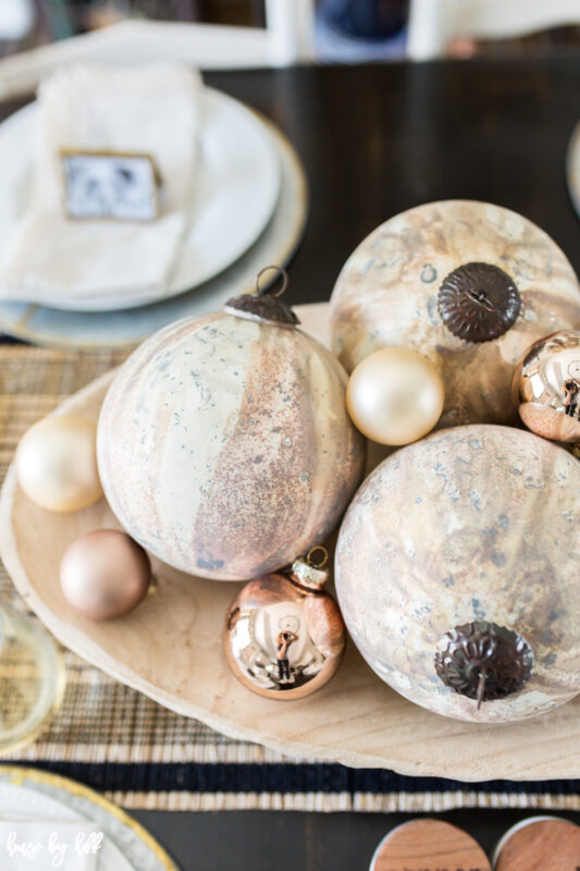 Large Copper and Cream Marbled Ornaments in Wood Bowl.