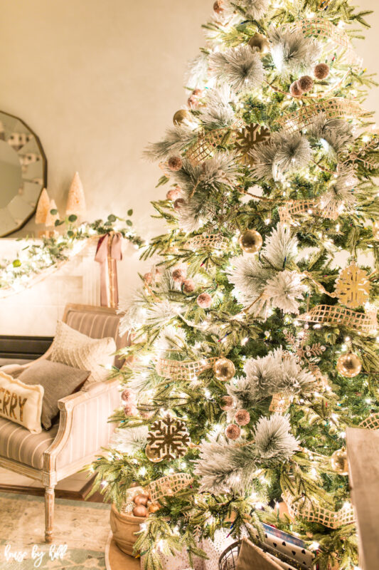 A Christmas tree decorated in gold and white with soft burlap.