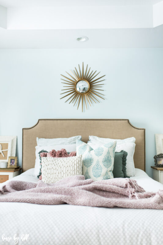 Master Bedroom with Upholstered Headboard and Starburst Mirror