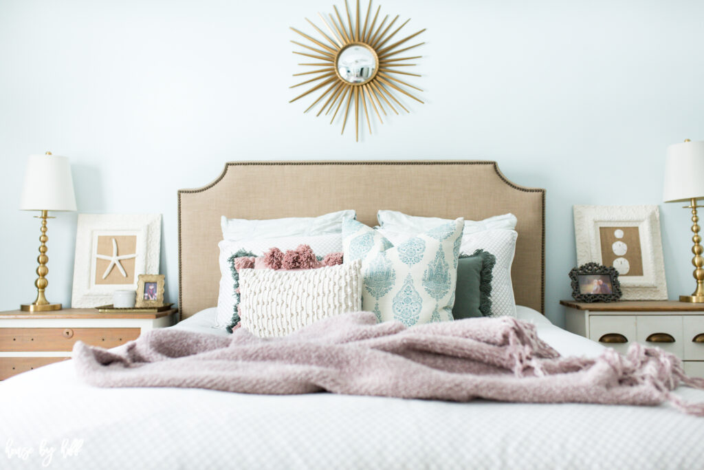 Master Bedroom with Beige Upholstered Headboard and throw pillows