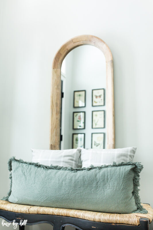 Oval Wood Mirror with Bench and Green Lumbar Pillow