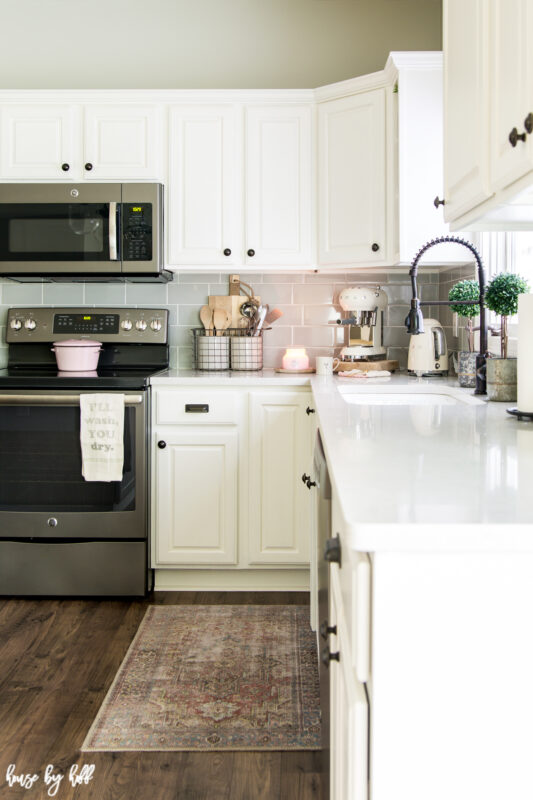 White Kitchen with Pops of Pink and Black Faucet