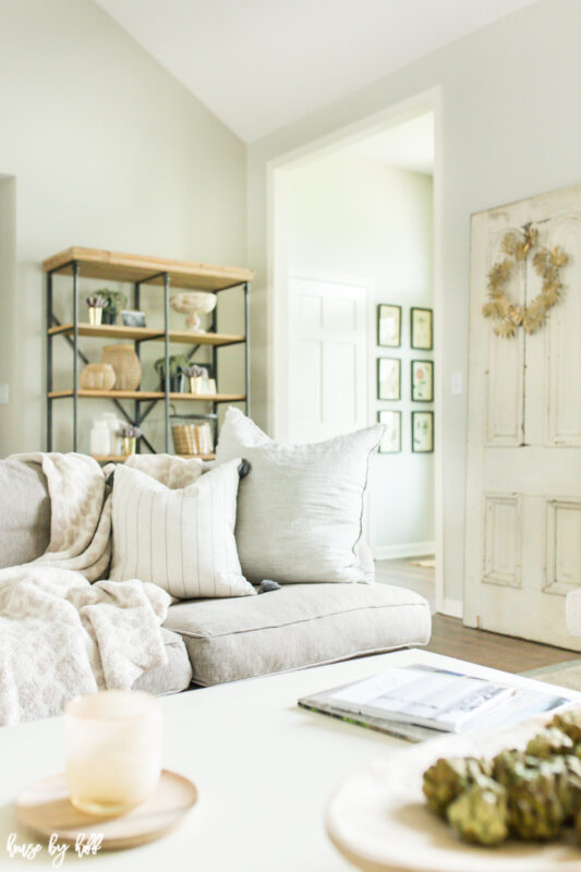 Open shelving behind the white couch in the living room.