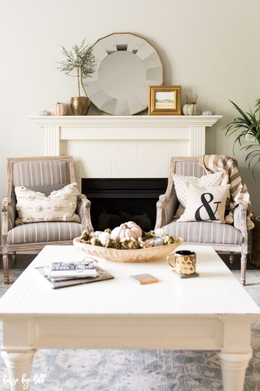 Neutral living room with fall decor and gold accents